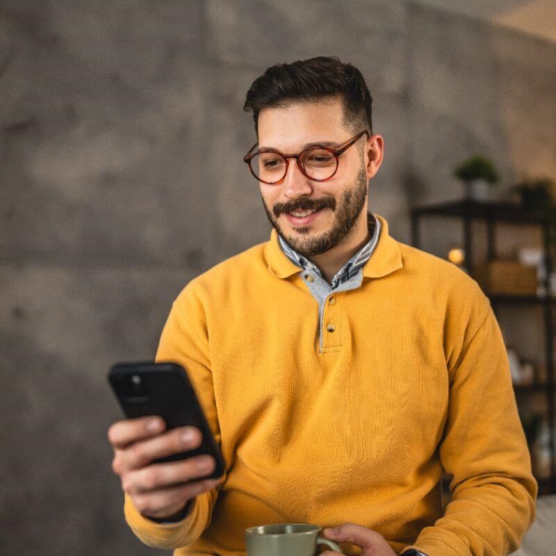 Man holding a phone and smiling